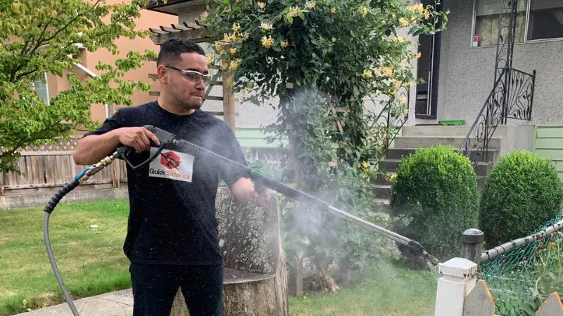 Power washing driveway surface with high-pressure water