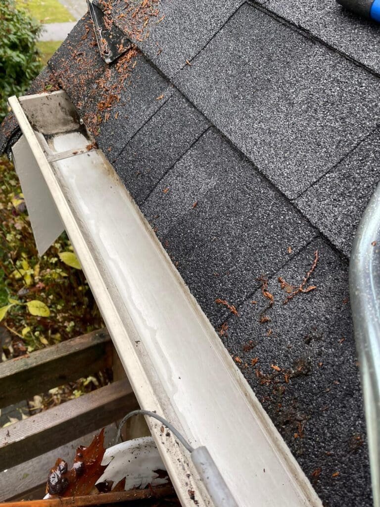 Debris-free, cleaned gutter after professional maintenance on a Vancouver residential roof