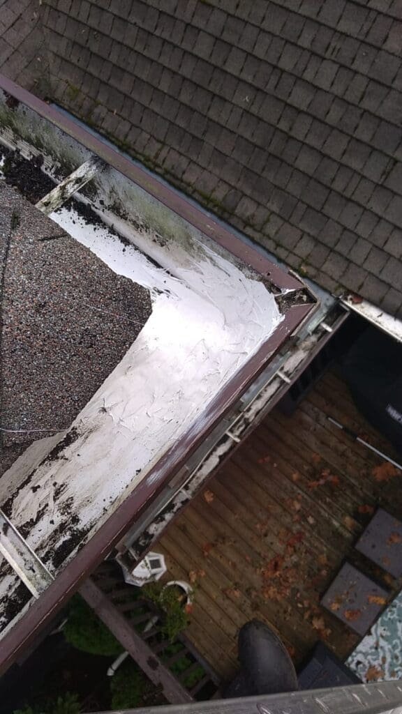 Technician caulking a gutter seam to prevent leaks on a Vancouver home