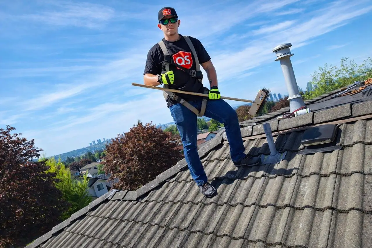 Quick Sidekick technician cleaning moss from a roof in Vancouver BC