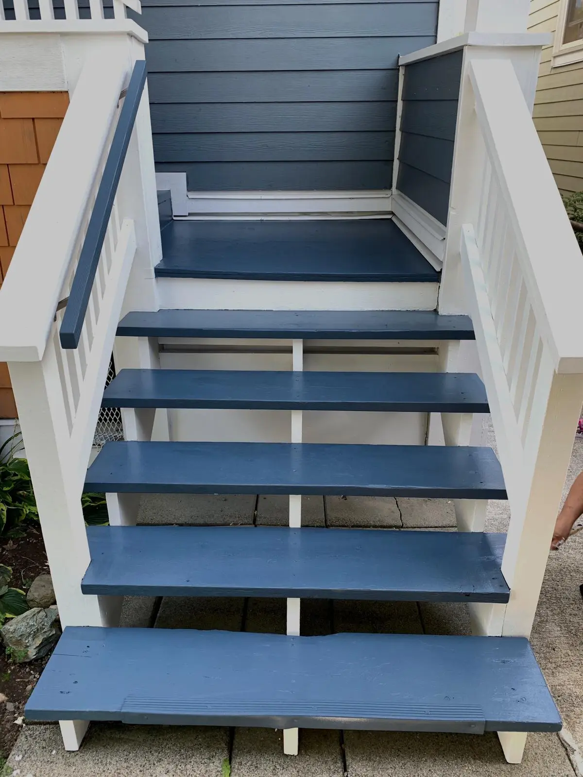 After deck stairs painting service in Burnaby showing freshly painted wooden stairs