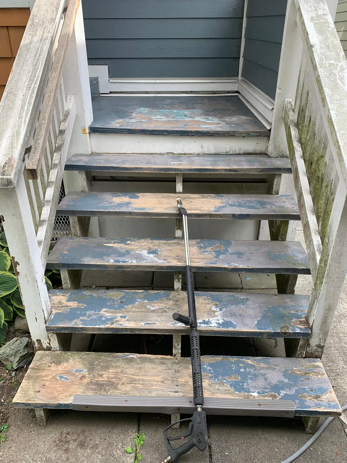 Before deck stairs painting in Burnaby showing worn and faded wooden stair surface