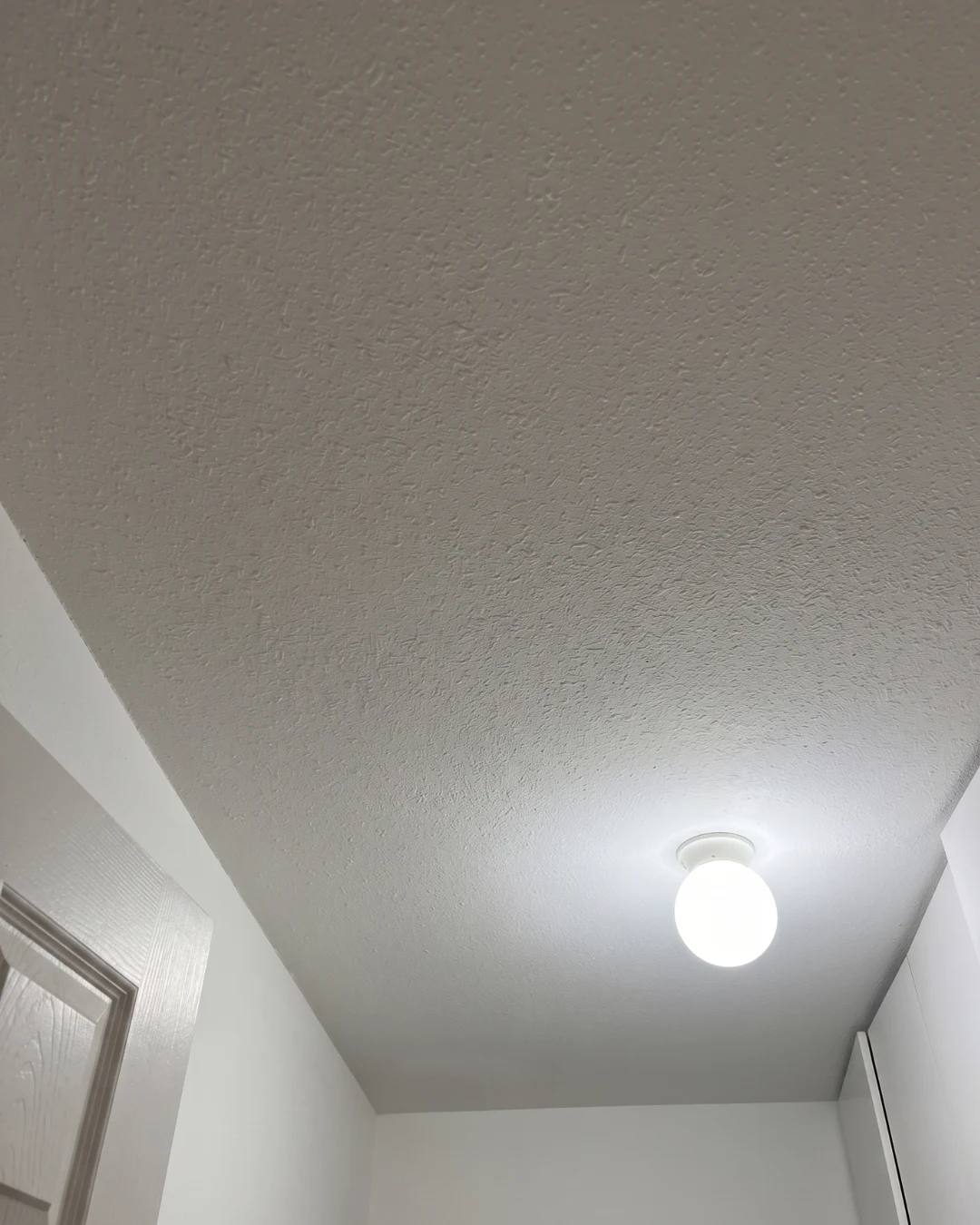 After ceiling popcorn removal drywall repair in Burnaby showing smooth clean ceiling finish
