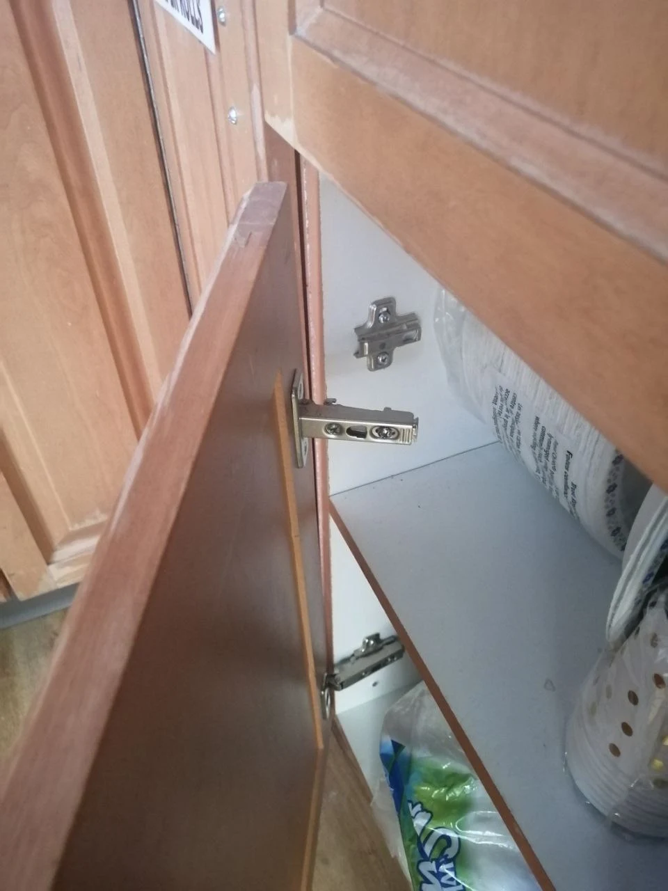 Before door hinge repair in Burnaby showing broken sagging door hinge causing door to drag and not close properly