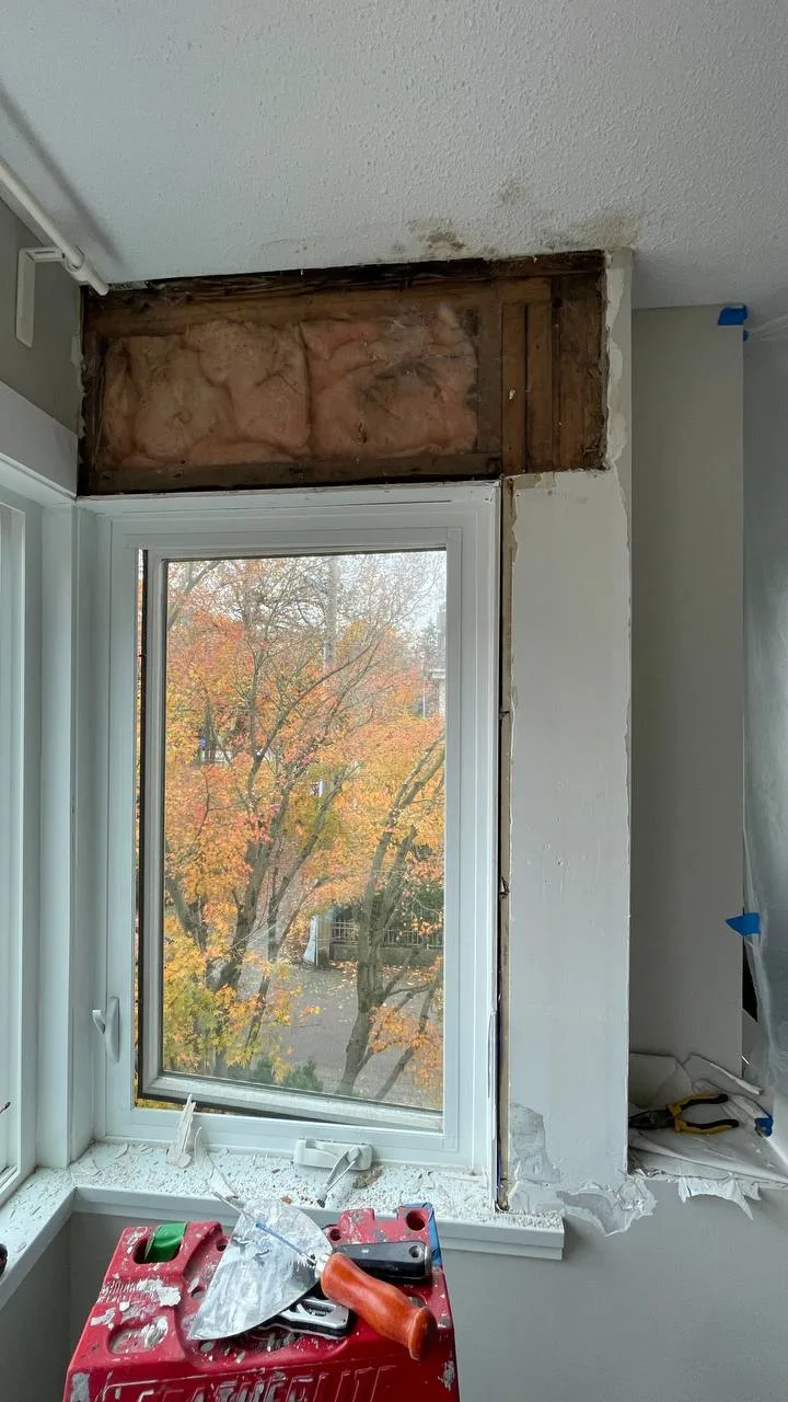 Before drywall repair in Burnaby showing deteriorated wall surface with water damage and cracked drywall