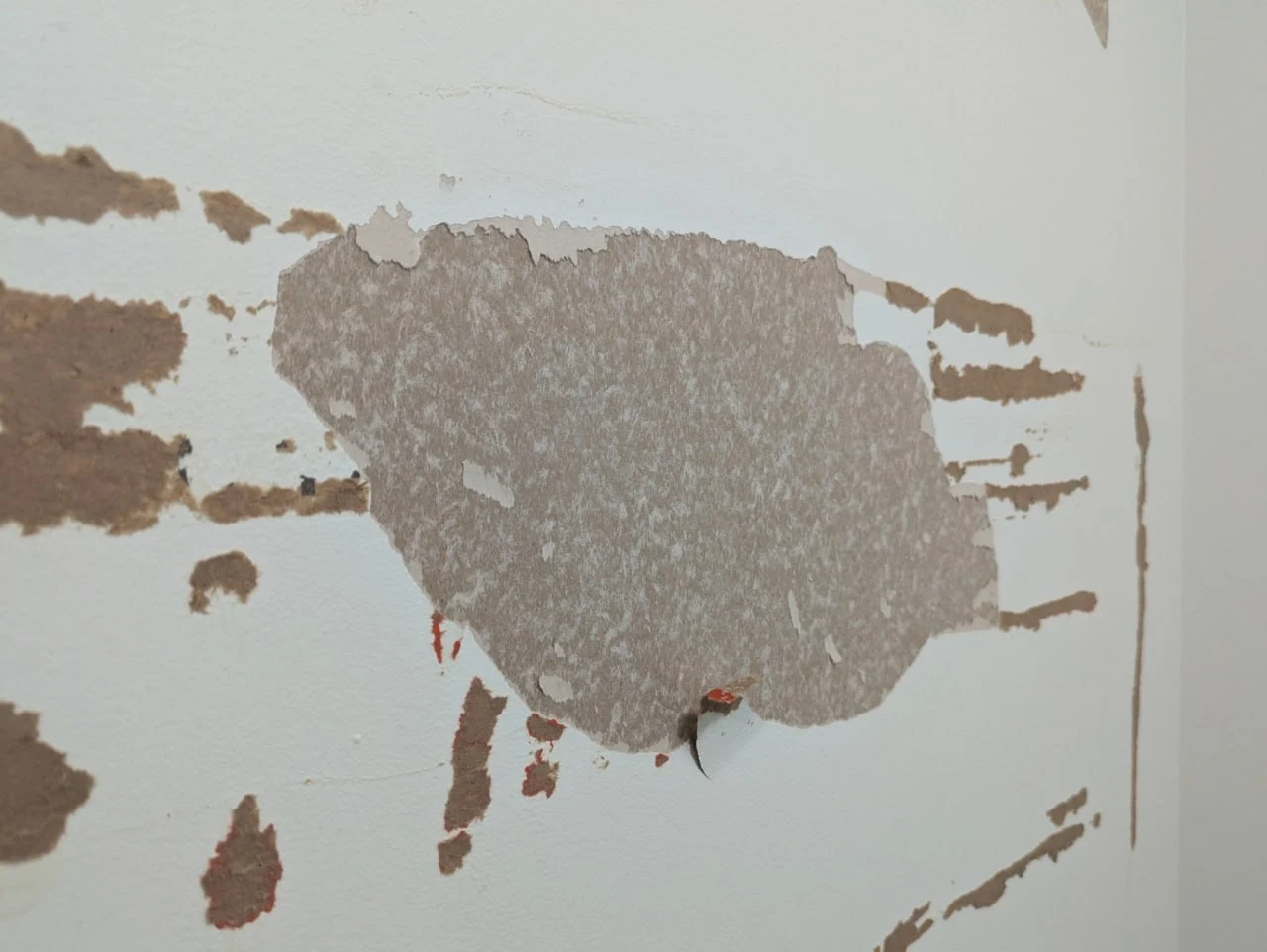 Before drywall repair in Burnaby showing damaged drywall with cracks and holes in interior wall