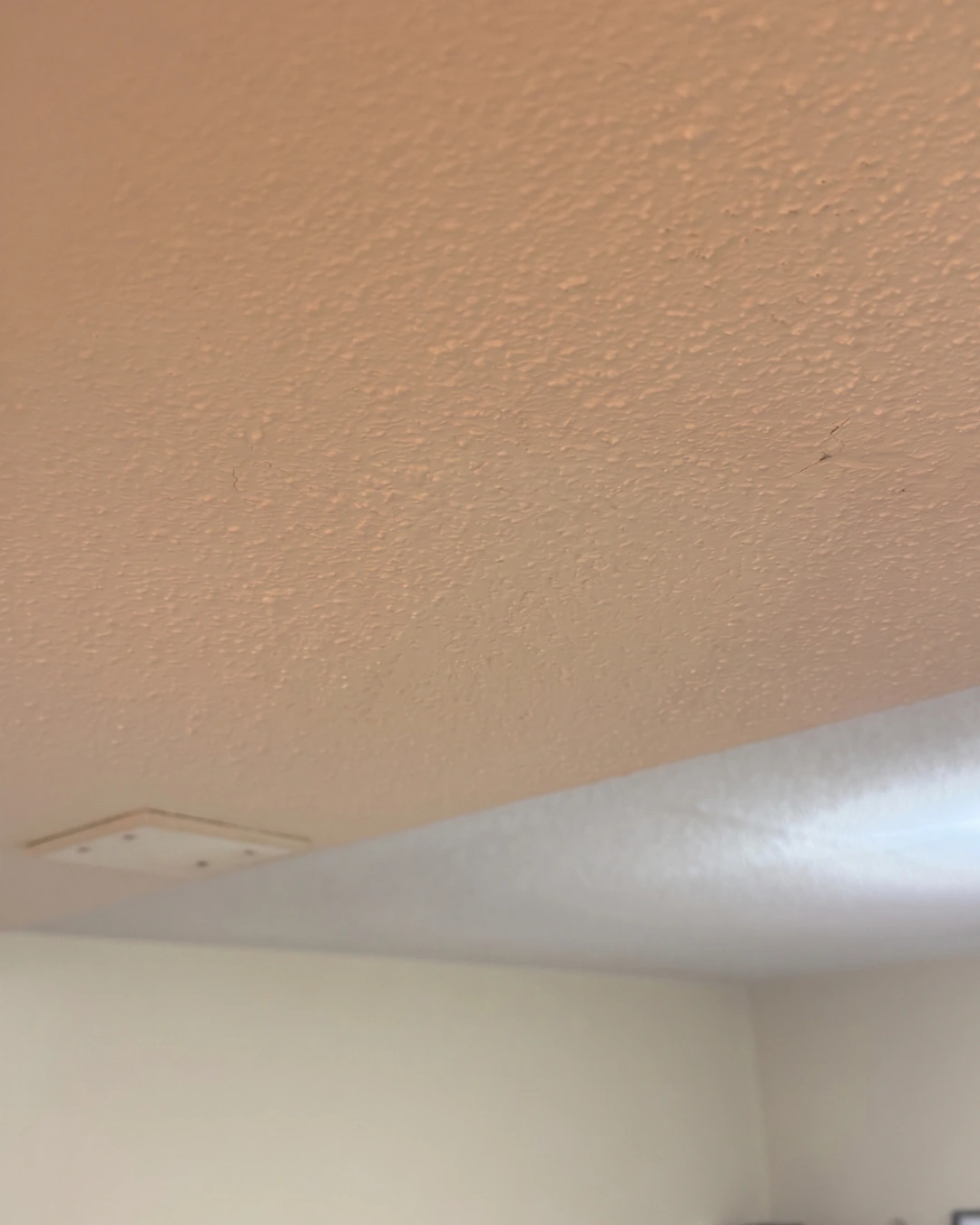After drywall popcorn ceiling repair in Burnaby showing freshly repaired ceiling with uniform smooth finish and no visible damage
