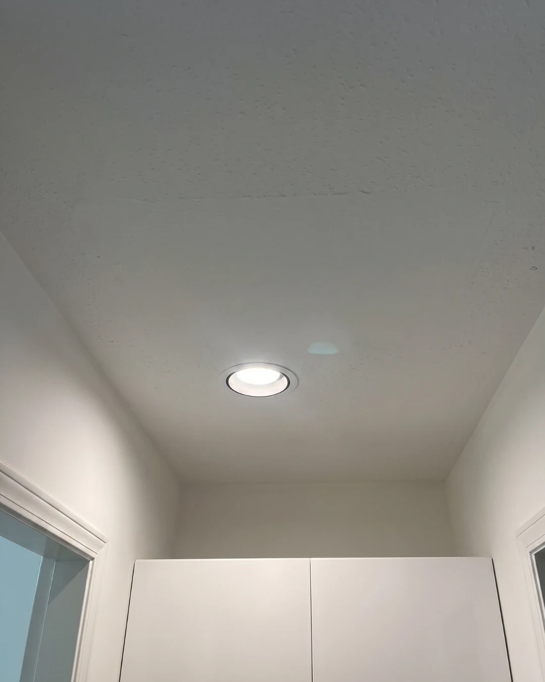 After drywall repair on popcorn ceiling in Burnaby showing fully restored ceiling surface with smooth finish and no visible imperfections