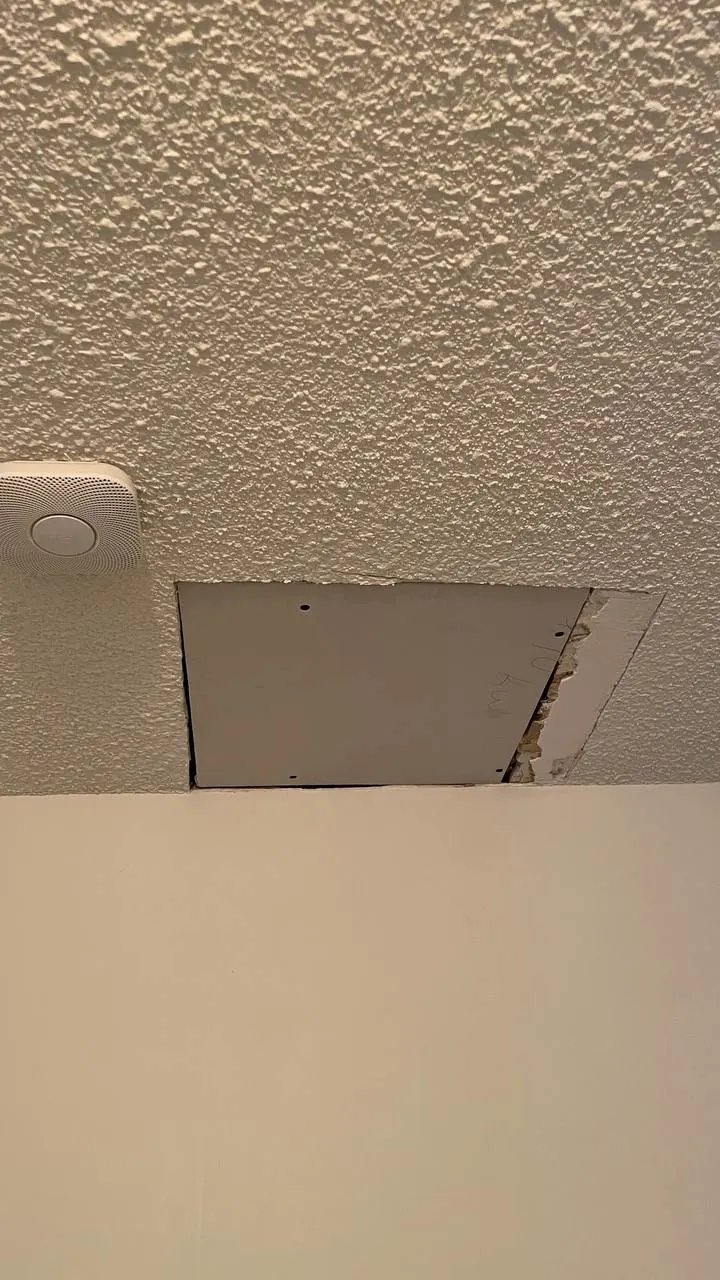 Before popcorn ceiling repair in Burnaby showing damaged textured ceiling with cracks and deterioration requiring professional drywall repair