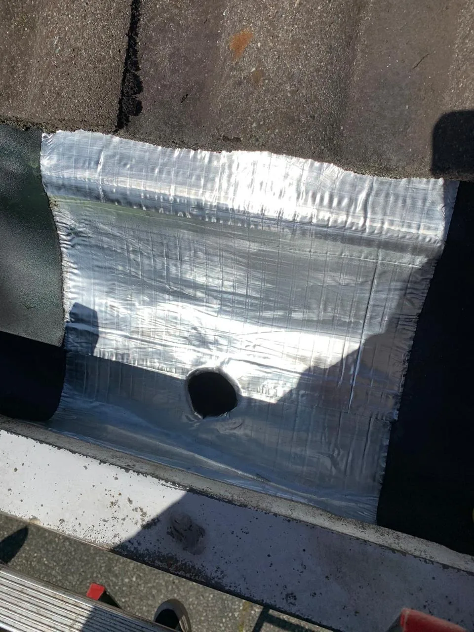 New aluminium roof flashing with sealed drain outlet after gutter repair in Vancouver BC