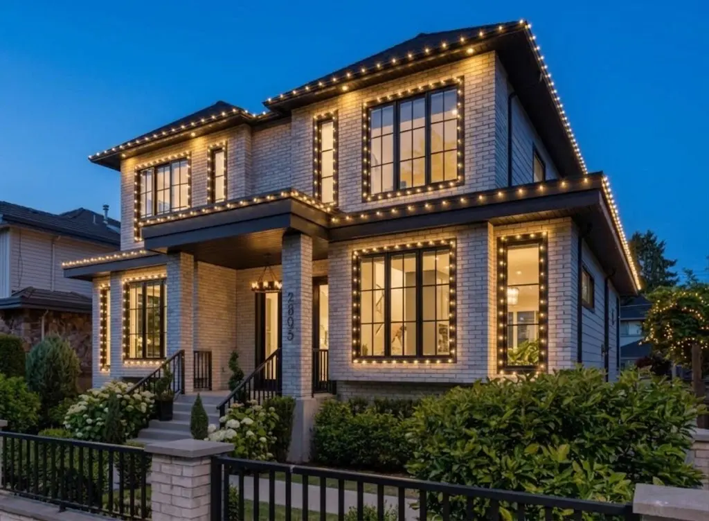 Christmas lights installed on two levels, sides and windows of a Vancouver home