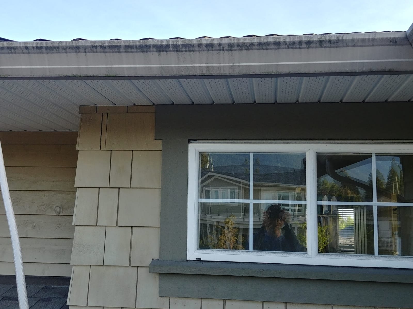 Stained exterior gutter before cleaning