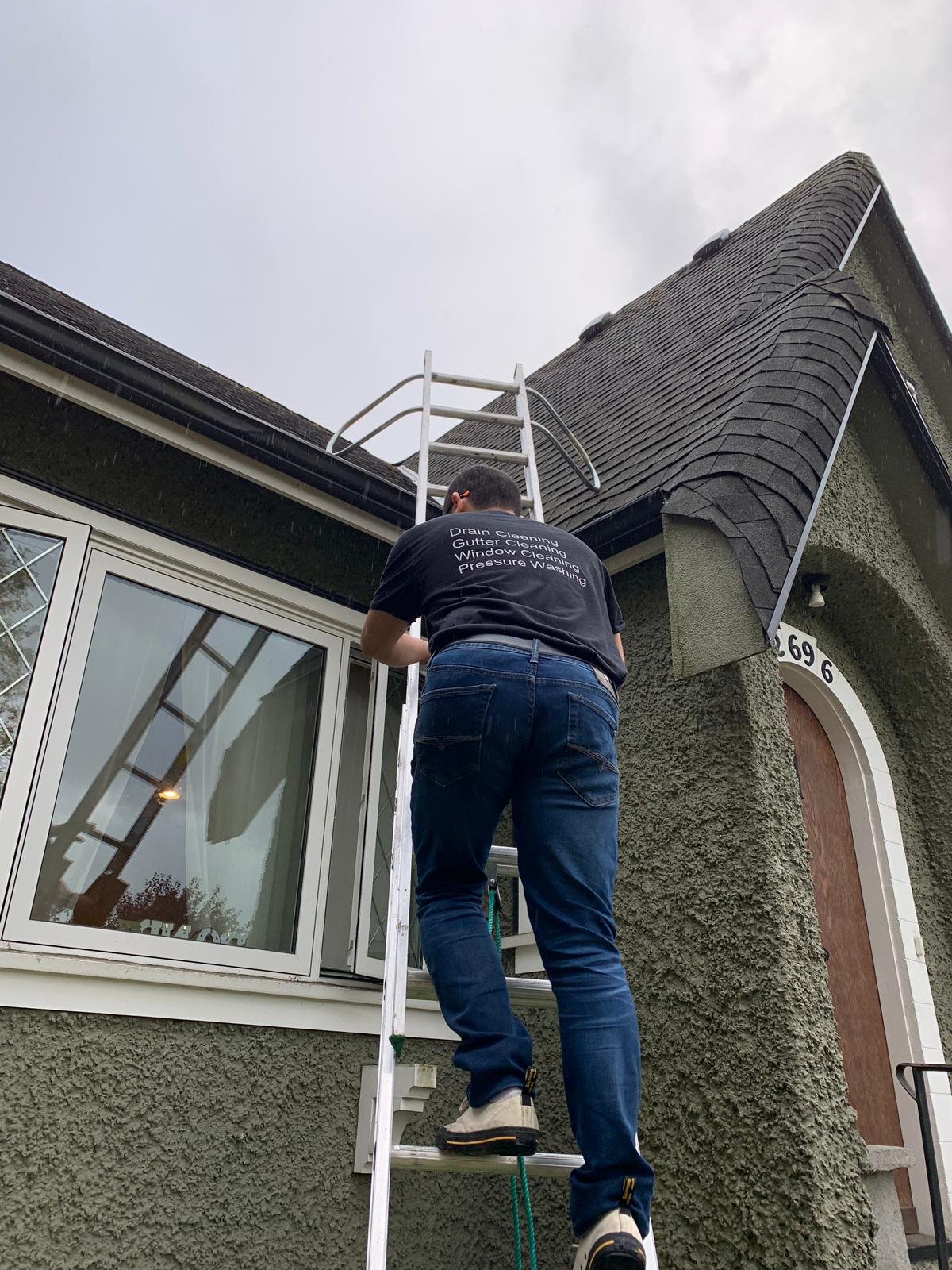 Inspecting a clogged gutter and downpipe