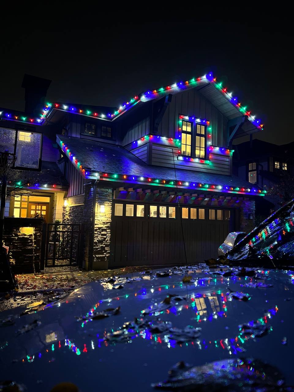 Christmas lights installed around windows and garage