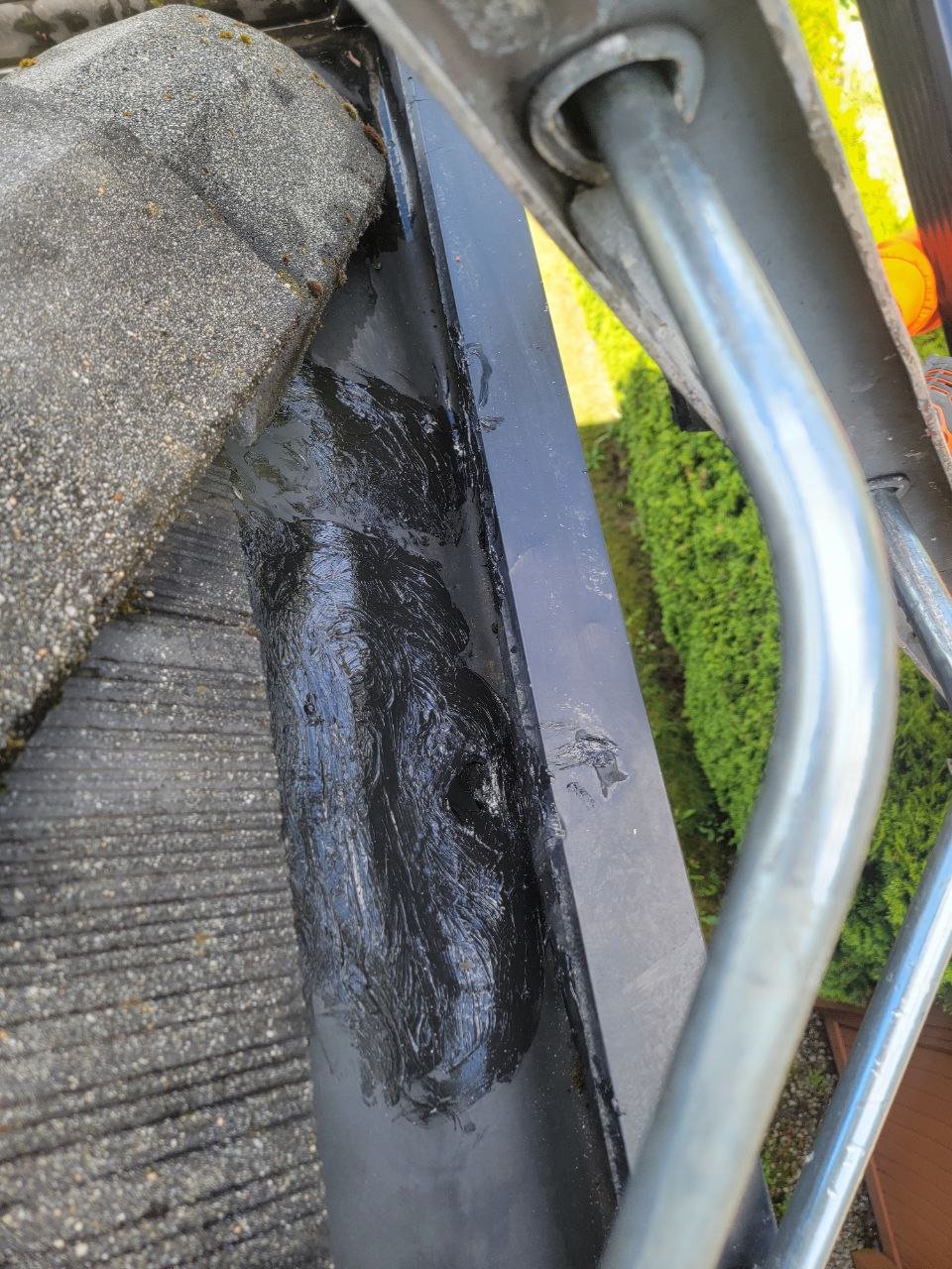 Technician sealing a seam inside a built-in gutter in Vancouver