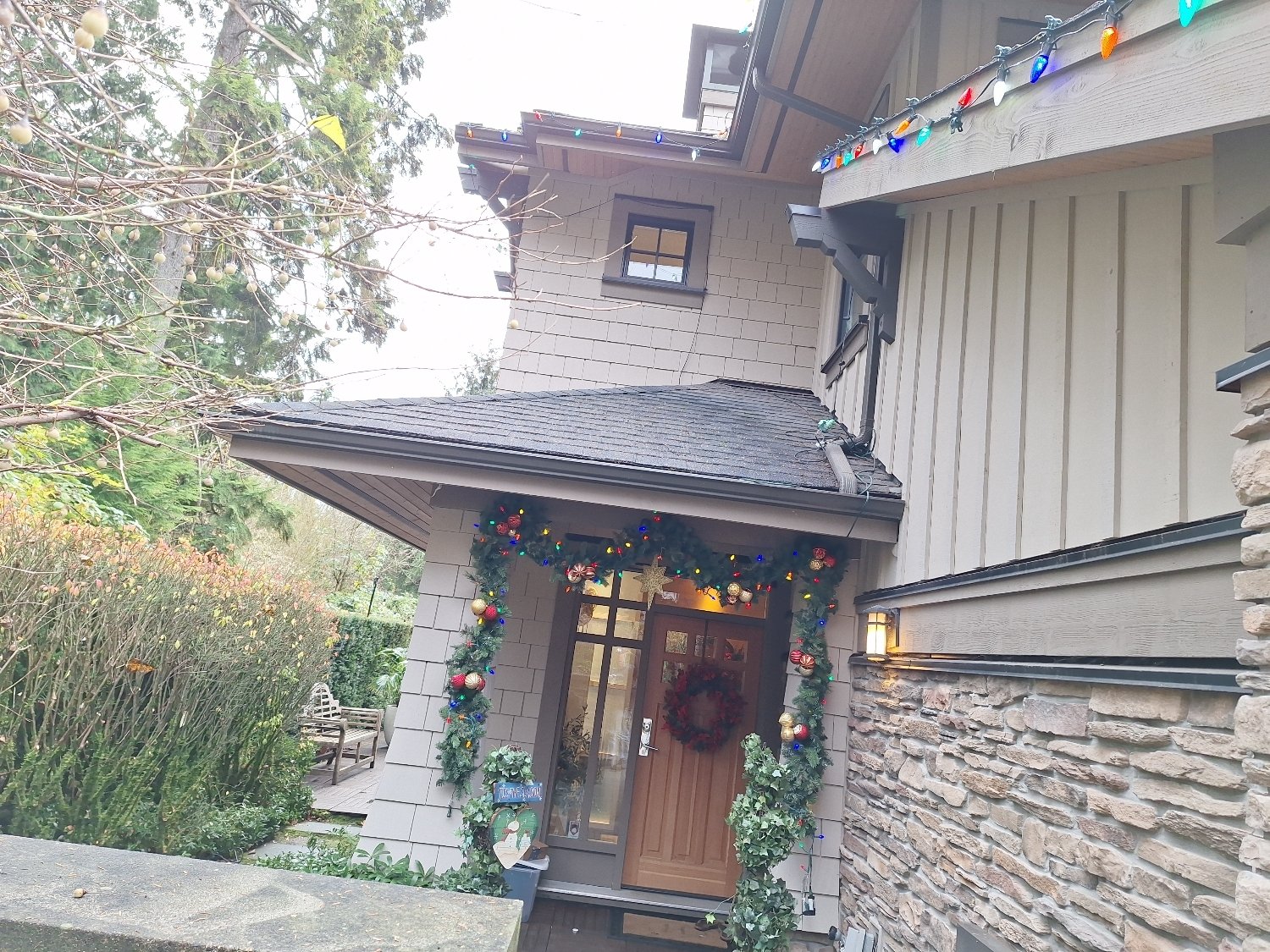 Christmas light installation around a front entrance