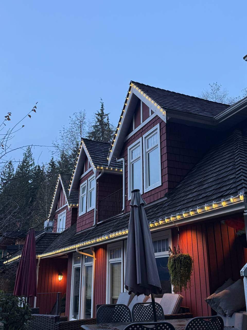 Christmas lights installed straight and evenly along a roofline