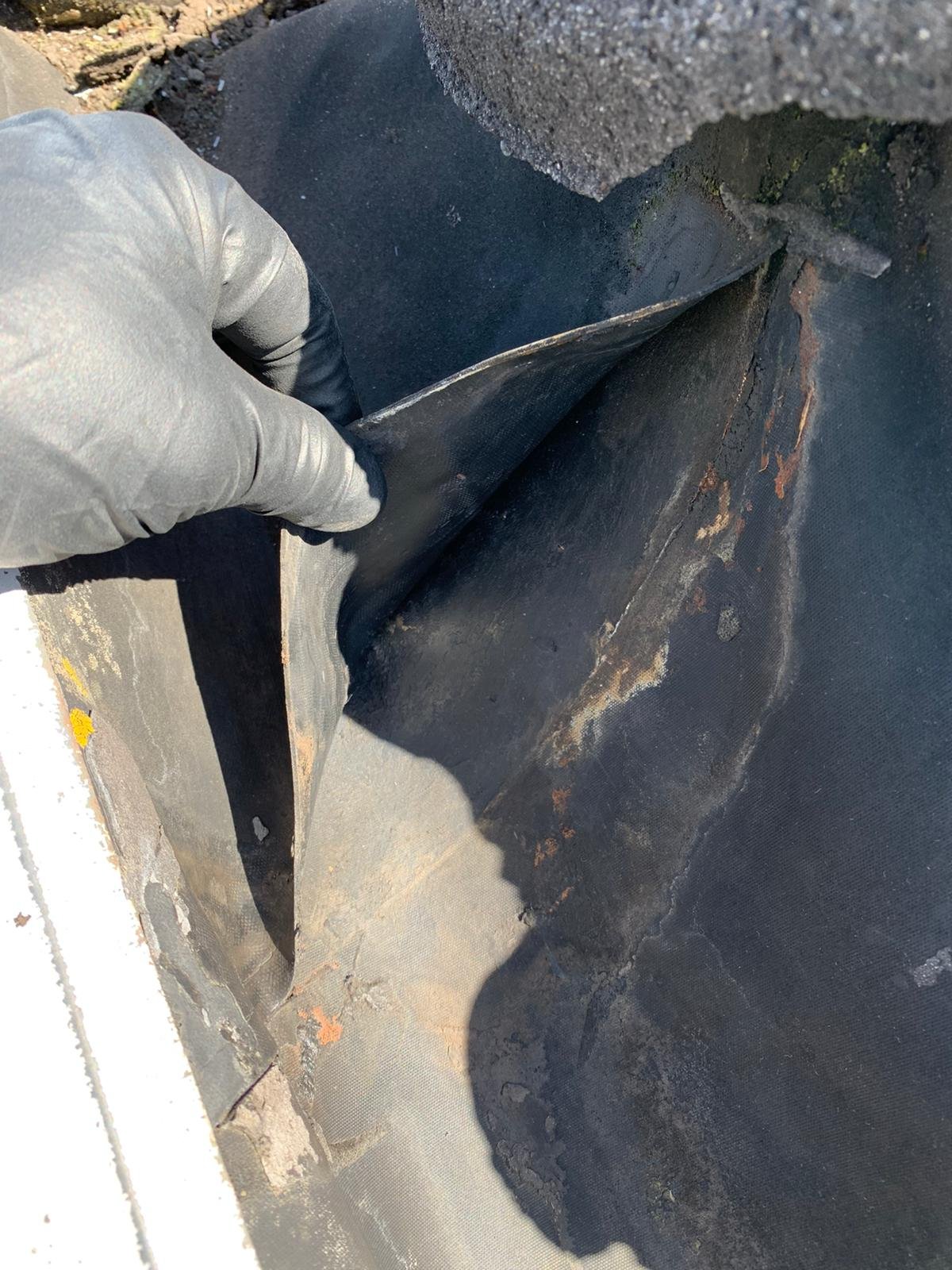 Ripped seam in a built-in gutter system in Vancouver