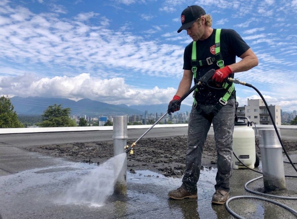 Controlled low pressure washing being used on a flat roof