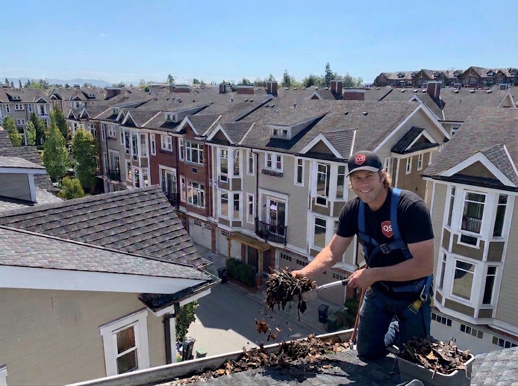 Commercial gutter cleaning technician servicing a building in Vancouver