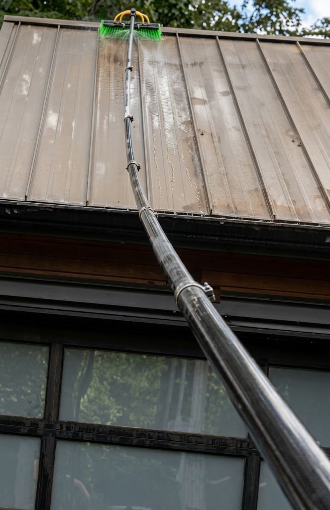 Water-fed Tucker pole cleaning a metal roof