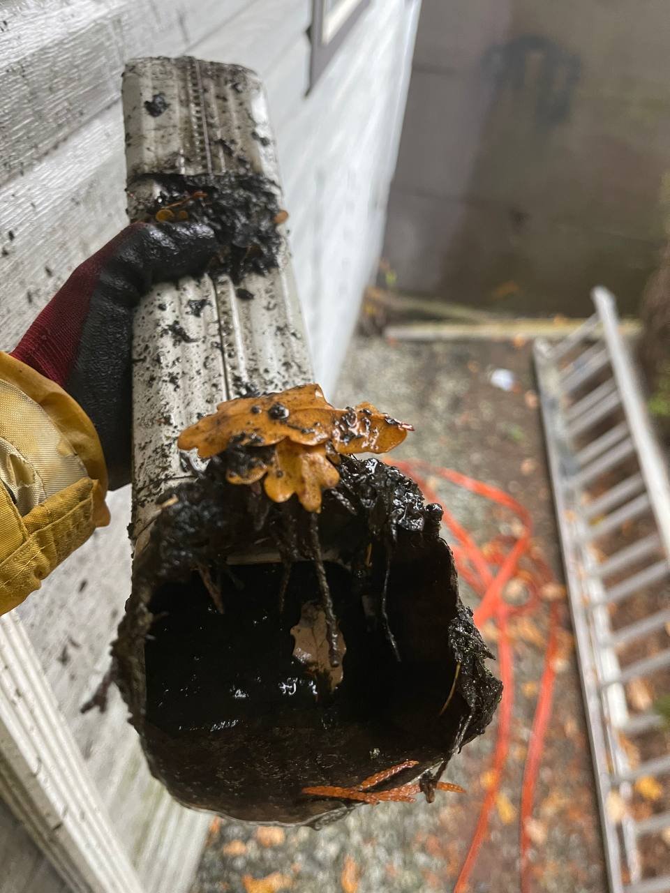 Clogged downspout being cleaned in Vancouver
