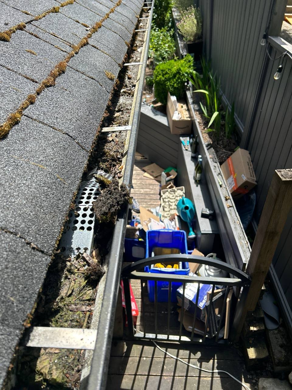 Gutter basket protecting downspout from leaves and debris