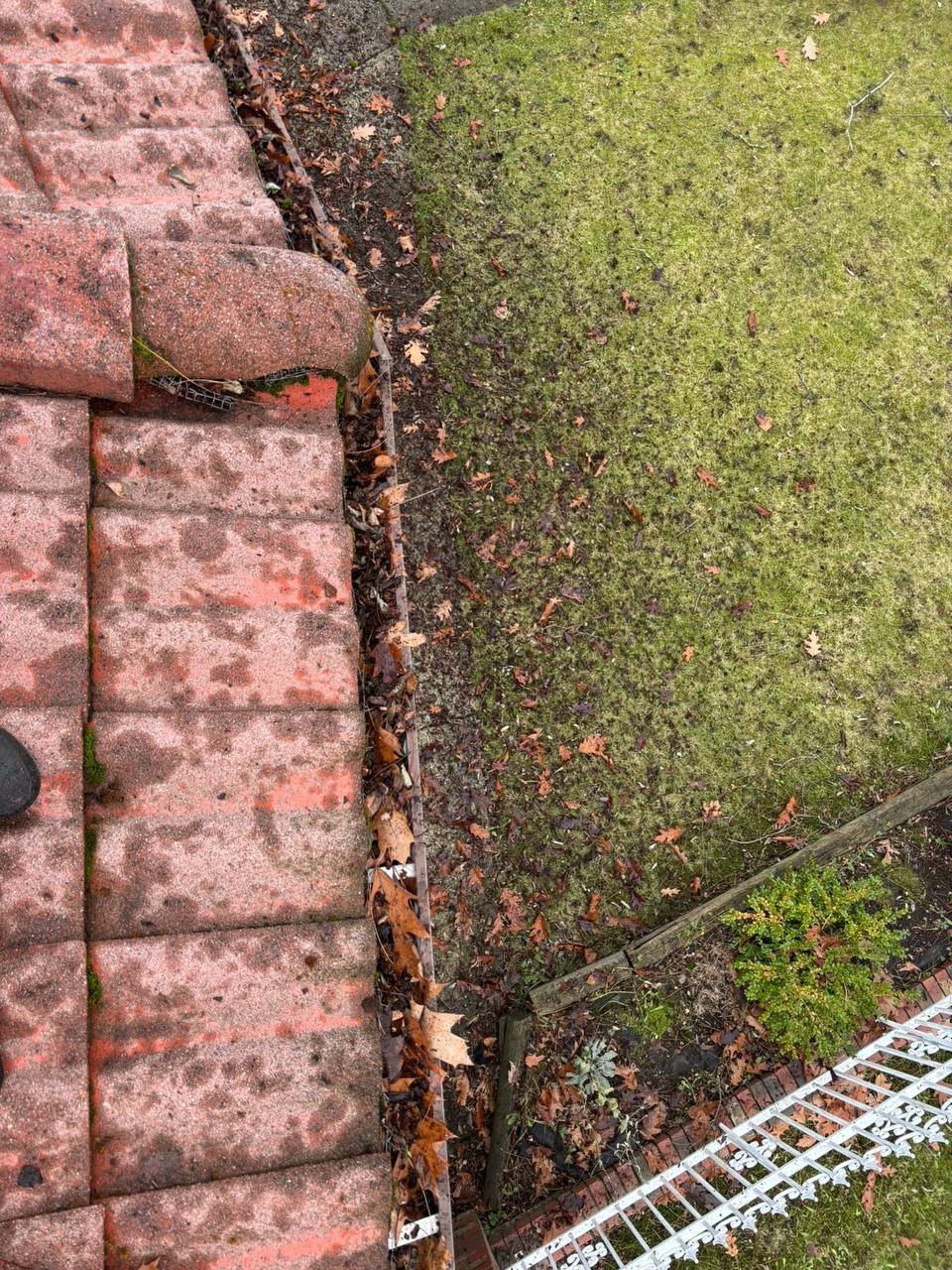 Older tile roof showing damaged and vulnerable roof tiles