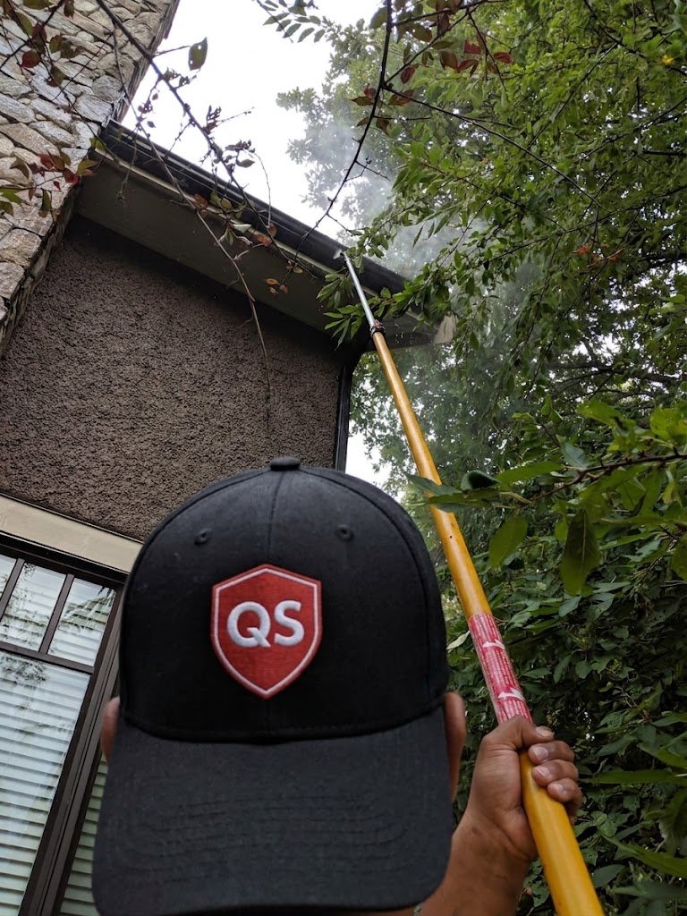 Power washing the exterior surface of a gutter