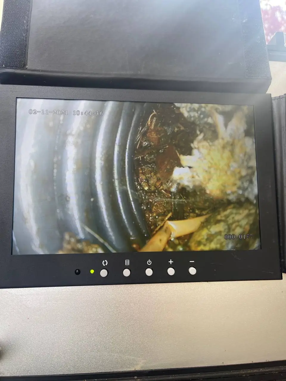 Camera inspection showing roots inside an underground drainage line
