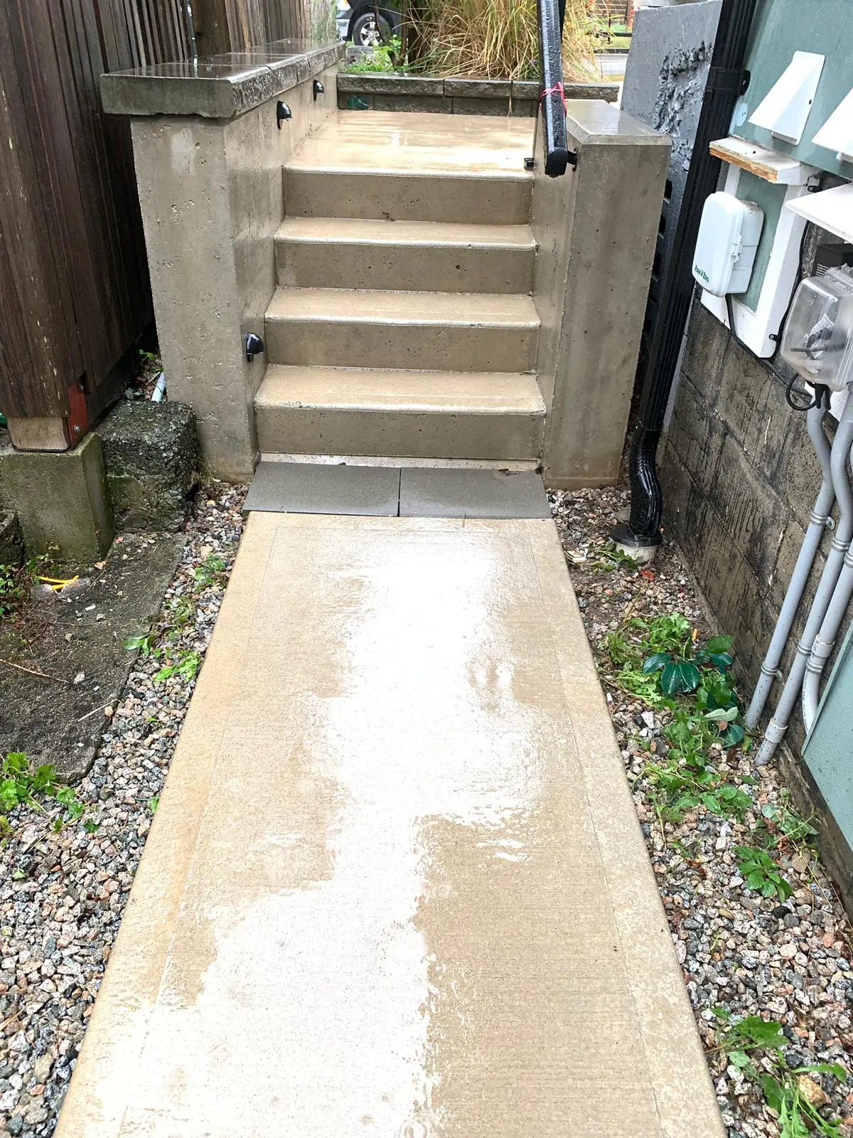 Clean concrete stairs and front entrance of a residential building