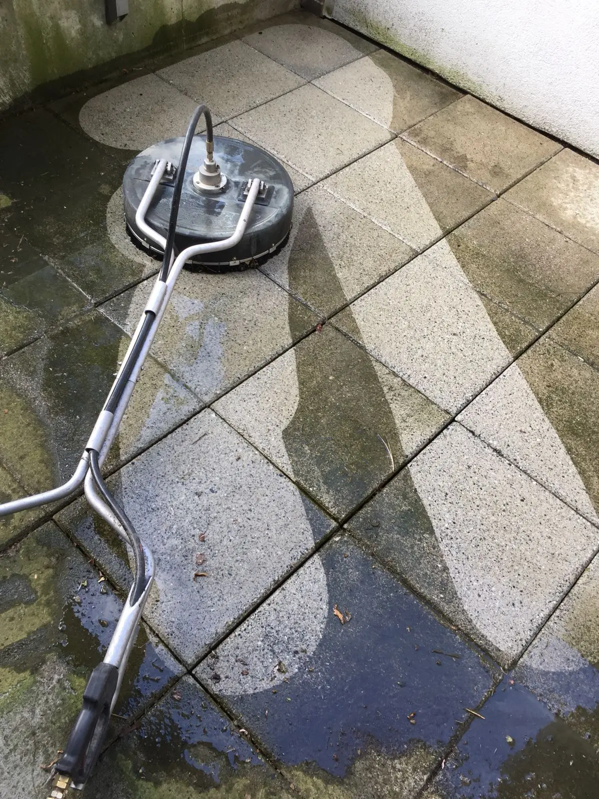 Pressure washing concrete paving stones with professional surface cleaning equipment